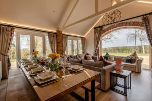 a dining room with a long table with flowers on it at 5 Bed in Haceby oc-c31061 in Haceby