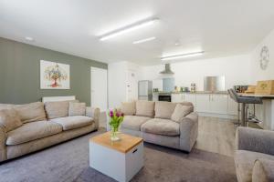 a living room with two couches and a table with flowers at 3 Bed in Bush oc-m31847 in Bude