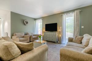 a living room with couches and a flat screen tv at 3 Bed in Bush oc-m31847 in Bude
