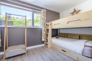 a bedroom with two bunk beds and a window at 3 Bed in Bush oc-m31847 in Bude