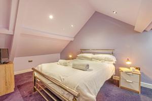 a bedroom with a large bed in a attic at 2 Bed in Tenby oc-w28985 in Tenby