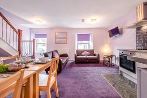 a kitchen and living room with a table and a couch at 2 Bed in Tenby oc-w28985 in Tenby