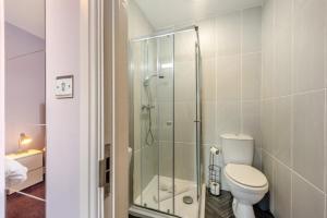 a bathroom with a toilet and a glass shower at 2 Bed in Tenby oc-w28985 in Tenby +15 photos