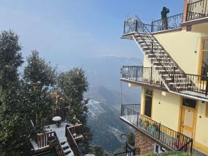 a view from the balcony of a building with stairs at HILL MOUNT Cabin Home in Chamba
