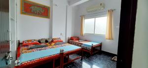 a small bedroom with a bed and a window at Gladden Villa in Udaipur +56 photos