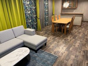 a living room with a couch and a table at 安全な個室貸切に広々した共用スペースの喜久屋コテージクレア in Yamanakako
