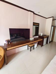 a bedroom with a wooden desk and a mirror at Grand Thai House Resort Lamai in Lamai
