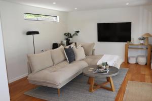 a living room with a couch and a table at Driftwood Studio in Mount Martha