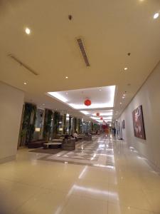 an empty lobby of a building with a long hallway at Gatotkaca Hotels in Surabaya