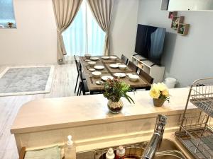 a living room with a table and a tv at Sunny Inn Sumida in Tokyo +27 photos