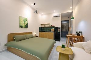 a bedroom with a bed and a living room at Sai Gon Stay-Hi-Tech Park Collection in Ho Chi Minh City