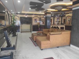 a living room with a couch and a table at Hotel Rising Sun in Bacha