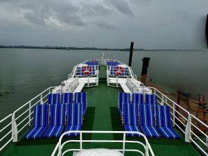 a ferry boat with blue chairs on the water at GiliTicket fast ferries in Padangbai