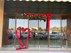 a store window with a valentines heart on display at Al Massa Plus Hotel in Al Ain