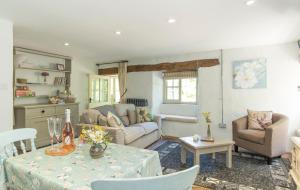 a living room with a couch and a table at Mill Cottage, Hanley Mill in Tenbury
