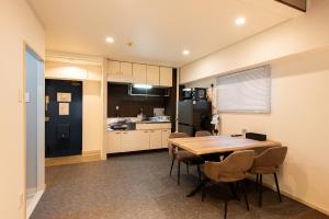 a kitchen and dining room with a table and chairs at StaySpring HARUYOSHI in Fukuoka