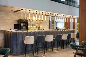 a bar with a row of stools in a restaurant at Afrosiyob Regency Hotel in Tashkent