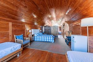 a bedroom with two beds in a wooden cabin at Villa Kappri in Natureʼs Valley +9 photos