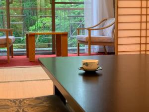 a coffee cup sitting on a table in a room at Blancvert Nasu Onsen Hotel in Nasu