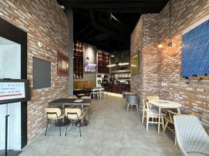 a restaurant with tables and chairs and a brick wall at Three Seven Hotel Dongdaemun in Seoul