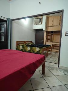 a living room with a bed and a kitchen at Himalayan siddh yog ashram in Rishīkesh +20 photos