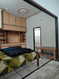 a room with a bed and a table in it at Himalayan siddh yog ashram in Rishīkesh