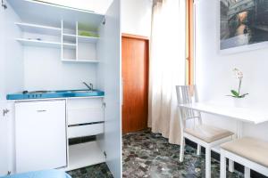 a kitchen and dining room with white cabinets and a table at Inlaguna in Venice