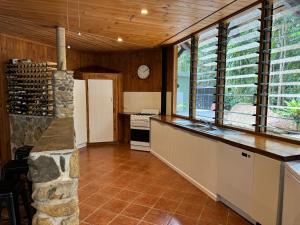 a kitchen with a counter and some windows at Daintree Cascades in Cape Tribulation +38 photos