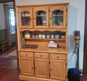a wooden hutch with cups and dishes in it at Nockold's Cottage in Denmark +9 photos