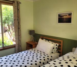 a bedroom with two beds and a window at Nockold's Cottage in Denmark