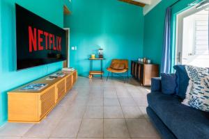 a living room with a tv and a couch at Southside Serenity of St Croix in Christiansted