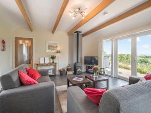 a living room with two couches and a tv at Strathmaddie Farm Cottage in Palnure