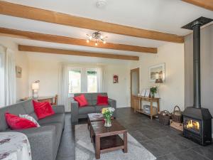 a living room with a couch and a fireplace at Strathmaddie Farm Cottage in Palnure