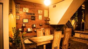 a dining room with a wooden table and chairs at Umah Bukit House in Uluwatu +42 photos