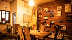 a dining room with a wooden table and chairs at Umah Bukit House in Uluwatu