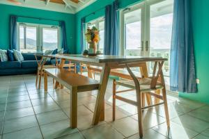a dining room with a wooden table and chairs at Southside Serenity of St Croix in Christiansted