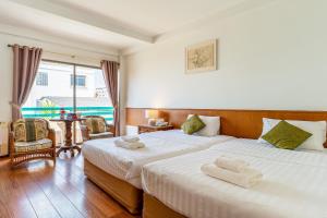 a hotel room with two beds with towels on them at Sirin Hotel Hua Hin in Hua Hin +65 photos