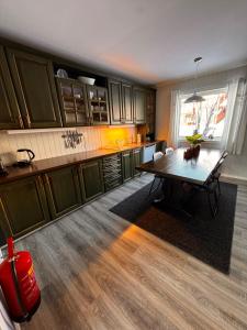a kitchen with a table in the middle of it at Ustedalen Lodge, Appartement 1 in Geilo