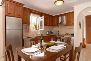 
a kitchen that has a table and chairs in it at Dimitris Apartments in Sidari
