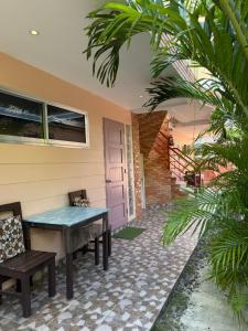 a patio with a table and two chairs at Logan Apartments in Bantayan Island