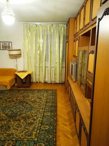 a living room with a bed and a tv and a couch at apartment Galitskaya Square in Kyiv