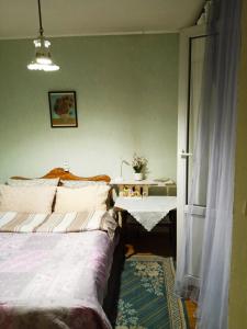 a bedroom with a bed and a table with a table at apartment Galitskaya Square in Kyiv