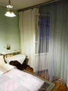 a small room with two beds and a window at apartment Galitskaya Square in Kyiv +3 photos