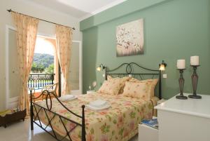 
a bedroom with a large bed and a large window at Dimitris Apartments in Sidari
