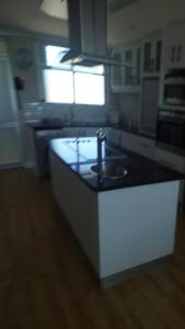 a kitchen with a sink and a counter top at Blouberg Heights in Cape Town