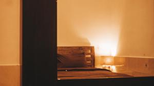 a bedroom with a bed with a light on it at Umah Bukit House in Uluwatu