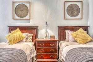 two beds sitting next to each other in a bedroom at French Bistro Studio in Johannesburg +20 photos