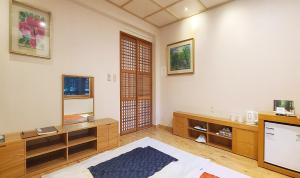 a room with a bed and a tv in a room at Nami Island Hotel Jeonggwanru in Chuncheon