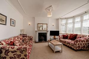 a living room with two couches and a fireplace at 4 Bed in Nottage oc-a32048 in Nottage