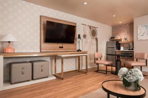 a living room with a flat screen tv on a wall at The Bentley Hotel Southampton in Southampton